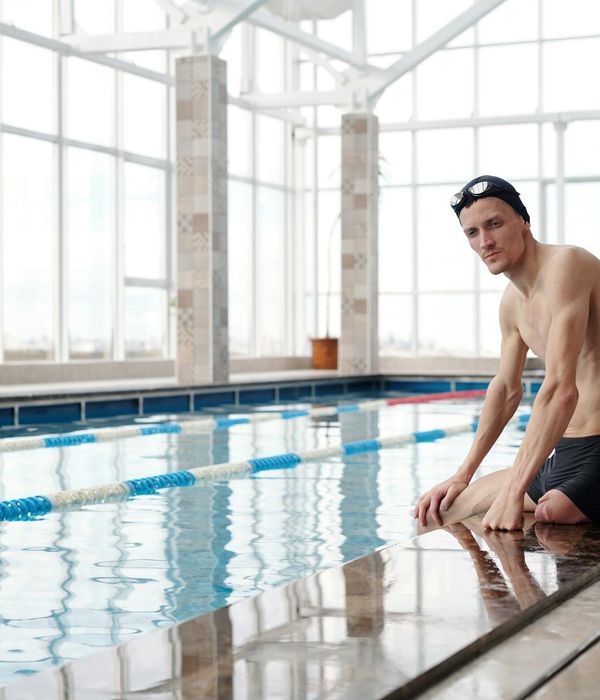 Man performing a strength exercise with focus and determination in a calm environment.
